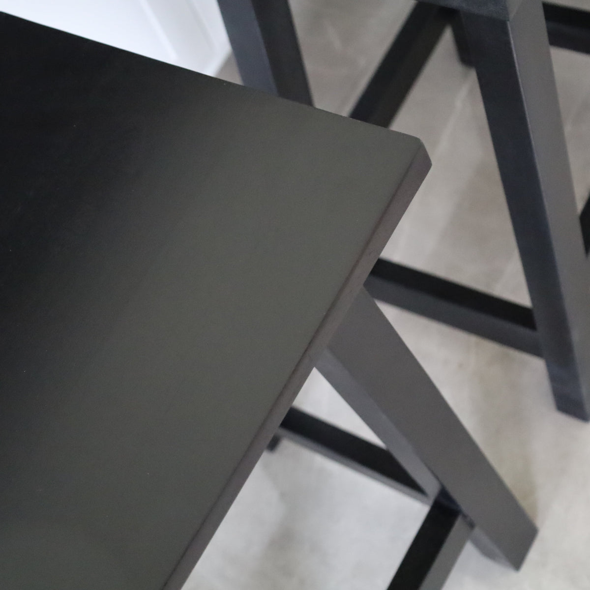 Maya black wooden stool close-up top – minimalist compact seating, buy online in Australia