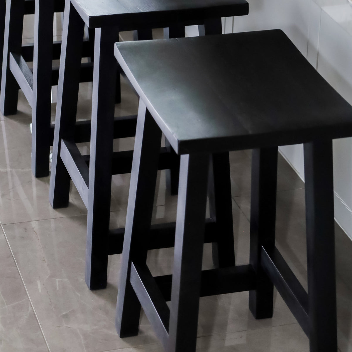 Maya black stool angled view – smooth seat and sturdy legs, 45cm, buy online in Australia